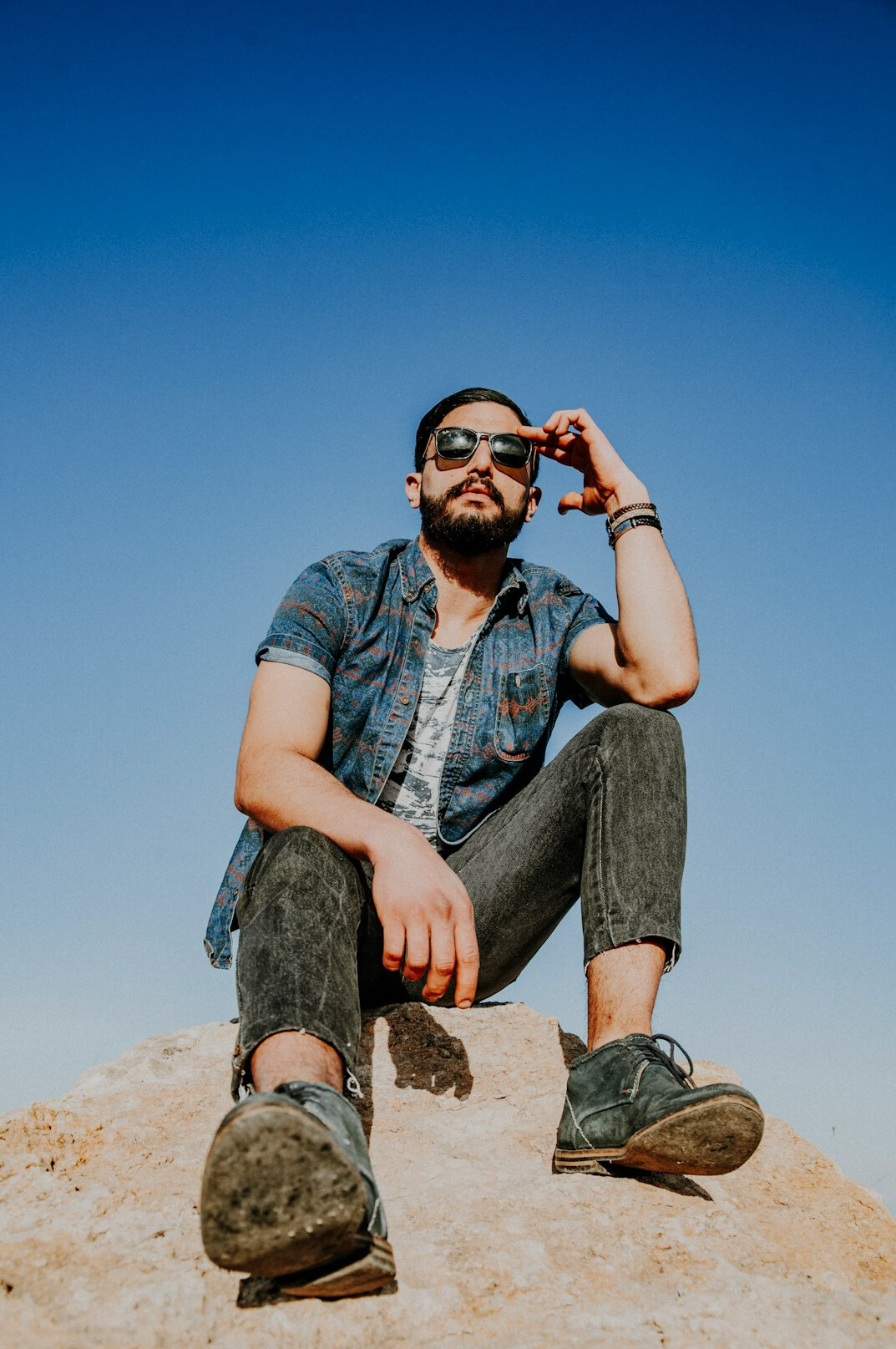 Man with a beard and glasses smiling in a study