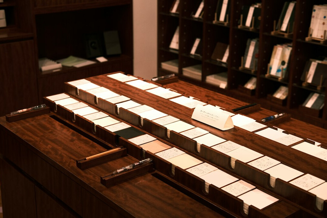 Old documents, pen and magnifying glass on a wooden desk